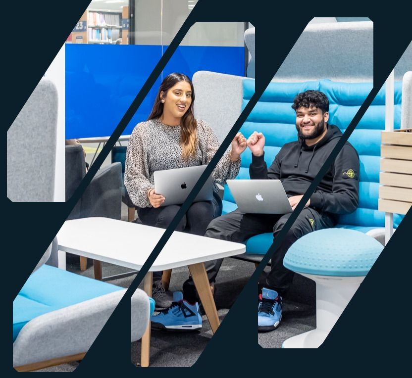 University students with laptops bumping fists